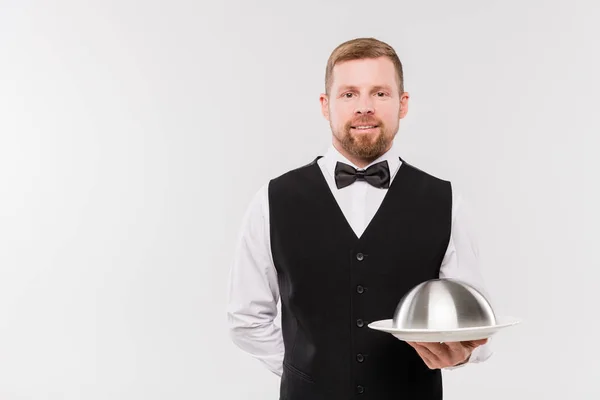 Happy Young Waiter Waistcoat Bowtie Holding Cloche Meal While Standing — ストック写真