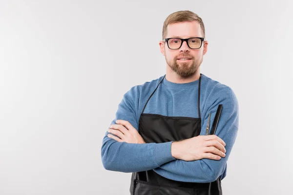 Happy Young Bearded Hairdresser Apron Eyeglasses Crossing Arms Chest While — ストック写真