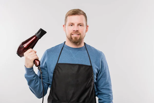 Young Bearded Hairdresser Apron Blue Pullover Holding Hairdryer While Standing — ストック写真