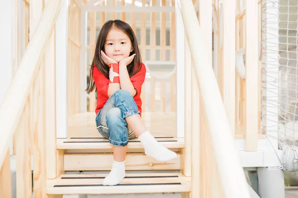 Adorable Asian Girl Casualwear Sitting Wooden Stairs Play Area Railings — Stock Photo, Image