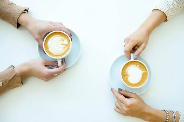 Top View Hands Two Friendly Females Holding Cups Cappuccino While — Stock Photo, Image