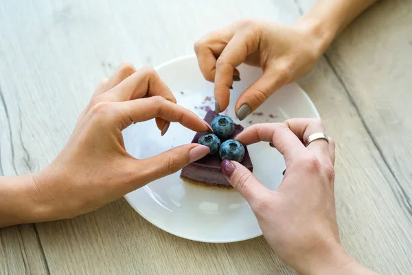 Hands Two Girls Taking Blueberries Top Tasty Cheesecake Plate While — Stock Photo, Image