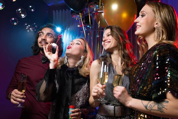 Glamorous Girl Blowing Soap Bubbles Friends Flutes Champagne Birthday Party — Stock Photo, Image