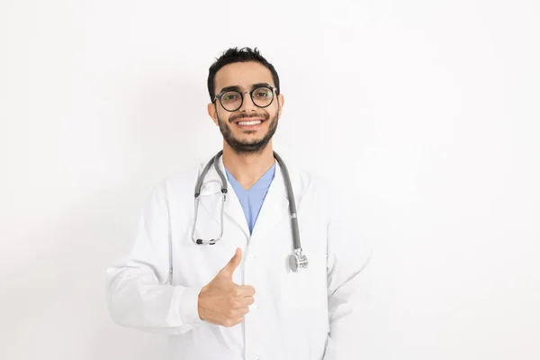 Young Smiling Clinician Eyeglasses Whitecoat Showing Thumb While Standing Front — 스톡 사진