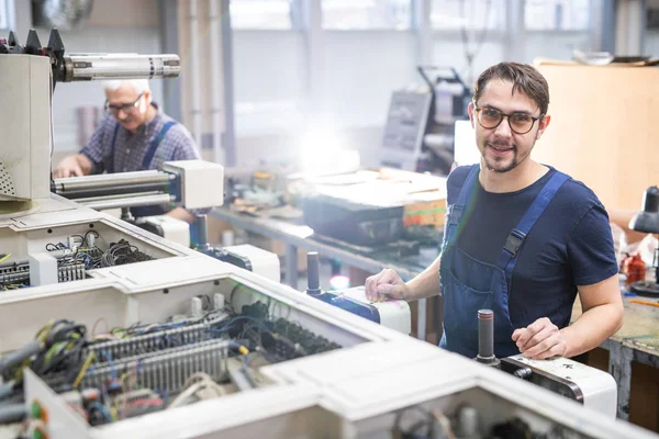 Porträtt Positiv Ung Ingenjör Glasögon Som Arbetar Med Tryckpressar Industrifabrik — Stockfoto