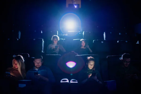 Groupe Jeunes Mobiles Faisant Défiler Leur Téléphone Intelligent Dans Cinéma — Photo