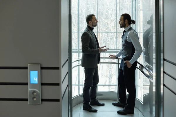 Dois Empresários Elegantes Discutindo Pontos Trabalho Termos Acordo Dentro Elevador — Fotografia de Stock