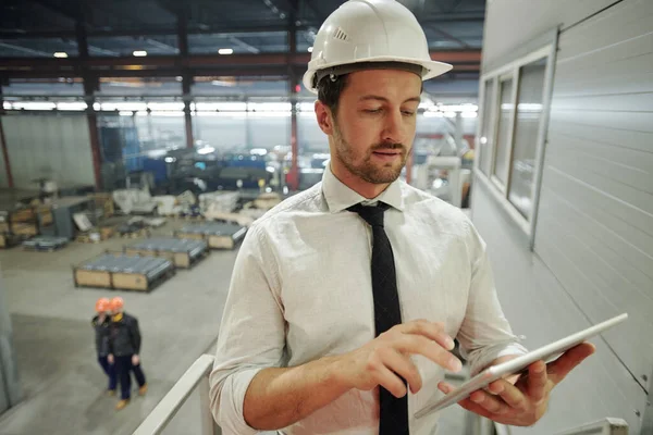 Vážný Mistr Hardhat Pomocí Mobilní Gadget Při Procházení Nové Technické — Stock fotografie