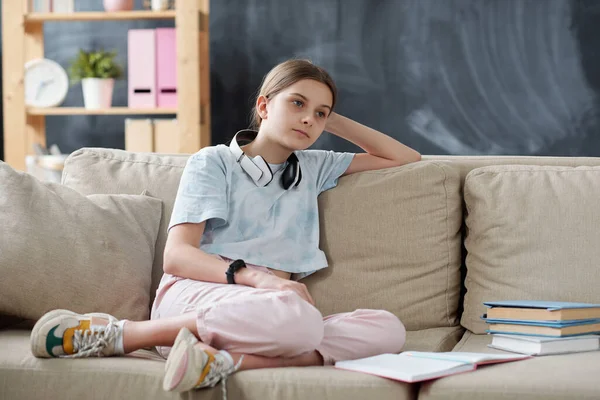 Pensive Attractive Teenage Girl Wireless Headphones Neck Sitting Sofa Textbooks — Stock Photo, Image