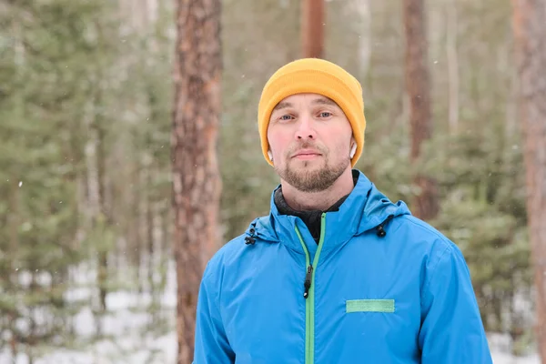 Portrait Serious Handsome Young Man Ear Buds Standing Winter Forest — Stock Photo, Image