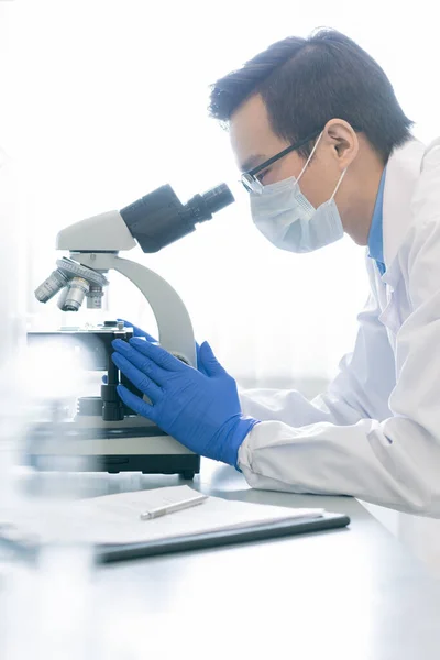 Vertical Side View Portrait Young Male Pharmacologist Examining Specimen Chemical — Zdjęcie stockowe