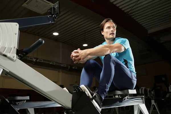 Rowing Machine Workout Low Angle View Caucasian Male Athlete Sitting — Stock Photo, Image
