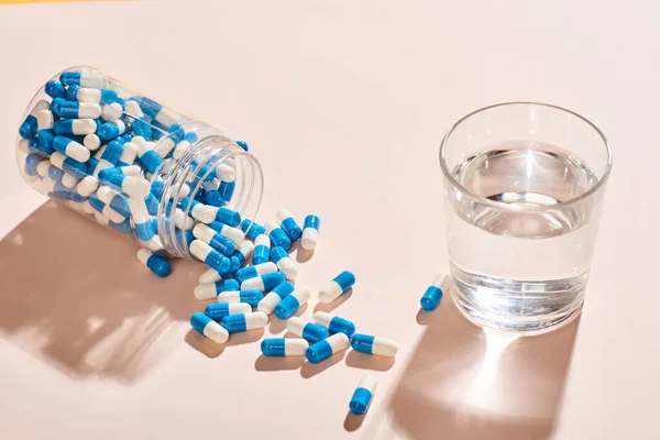 White Blue Capsules Spilled Out Fallen Bottle Glass Water Pale — Stock Photo, Image