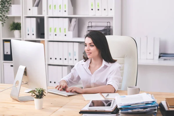 Positive Young Businesswoman Sitting Desk Typing Computer Keyboard While Composing — Stock Photo, Image