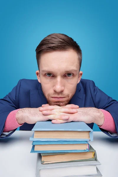 Young Serious Student Keeping Chin Hands Stack Books While Sitting — Stock Photo, Image