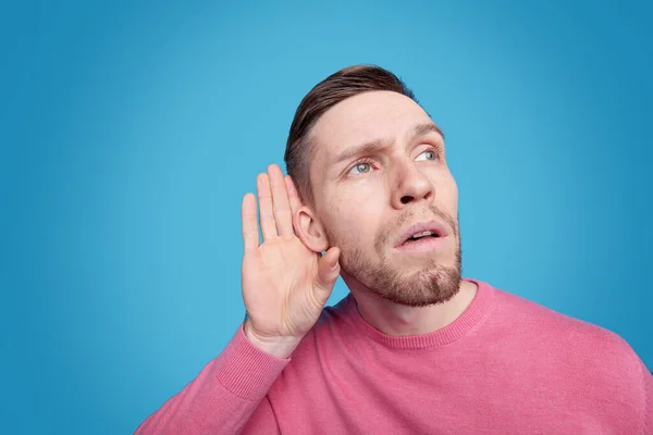 Junger Bärtiger Mann Rosafarbenen Pullover Hält Die Hand Rechten Ohr — Stockfoto