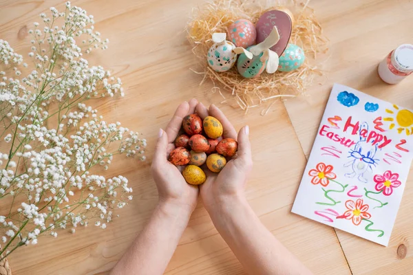 View Unrecognizable Woman Holding Painted Quails Eggs Wooden Table Easter — Stock Photo, Image