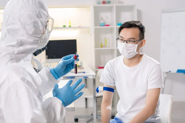 Sick Chinese Guy Protective Mask Sitting Front Lab Worker Gloves — Stock Photo, Image