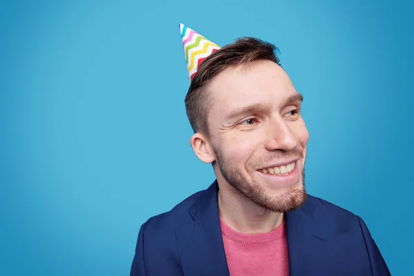 Happy Young Man Birthday Cap Head Looking Aside Toothy Smile — Stock Photo, Image