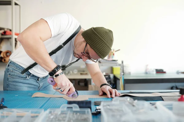 Young Craftsman Casualwear Beanie Bending Table While Cutting Piece Beige — Stock Photo, Image