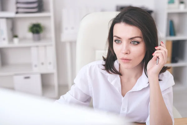 Joven Mujer Seria Camisa Blanca Sosteniendo Pluma Mano Mientras Mira — Foto de Stock