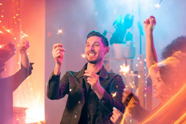 Happy Young Man Toothy Smile Looking Sparkling Bengal Lights His — Stock Photo, Image