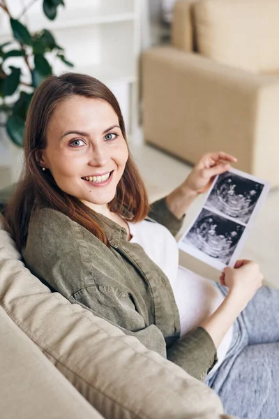 Portrét Pozitivní Mladé Těhotné Ženy Při Sledování Ultrazvukové Fotografie Dítěte — Stock fotografie