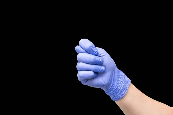 Fig som en handgest, som betecknar förnedring eller förnekelse. Manlig hand i lila latexhandske. — Stockfoto