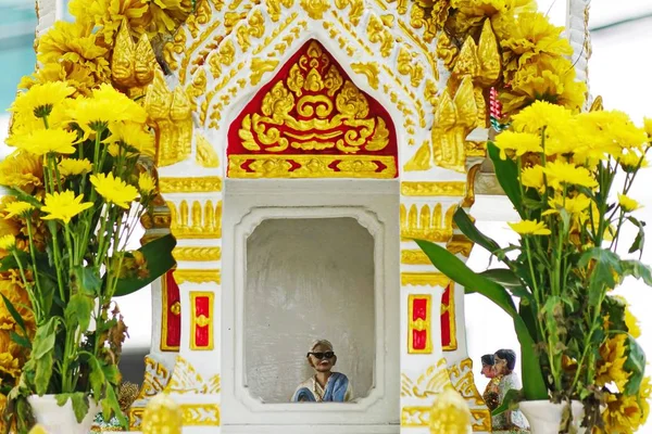 the mini doll inside thai spirit house or joss house.