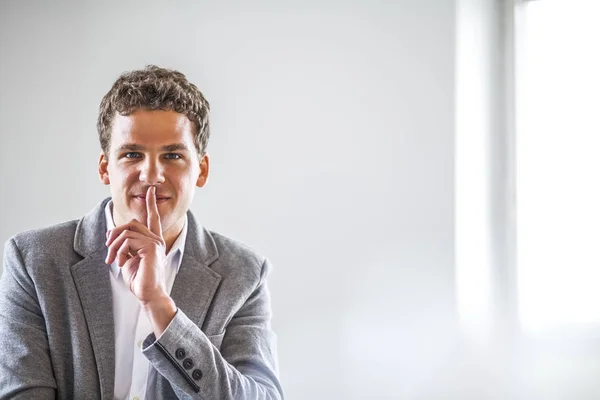 Πορτρέτο Του Νεαρός Επιχειρηματίας Δάχτυλο Στα Χείλη Στο Γραφείο — Φωτογραφία Αρχείου