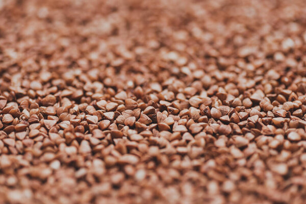 A close up of buckwheat grains. Raw porridge top view. Grain pattern. Vegan raw food.