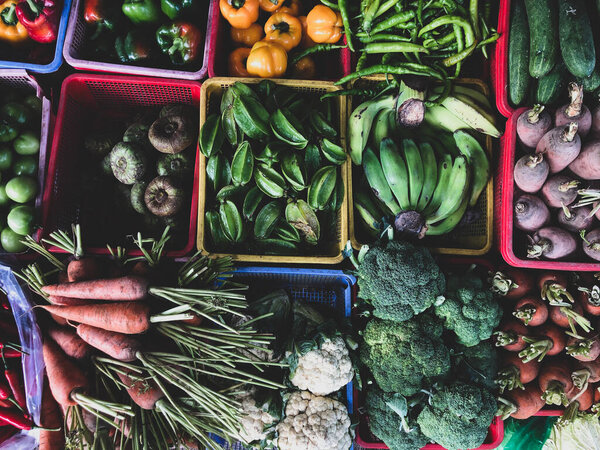 Top view on a large assortment of row loose vegetables and fruits for sale in a street. Short circuit production at Hue Market