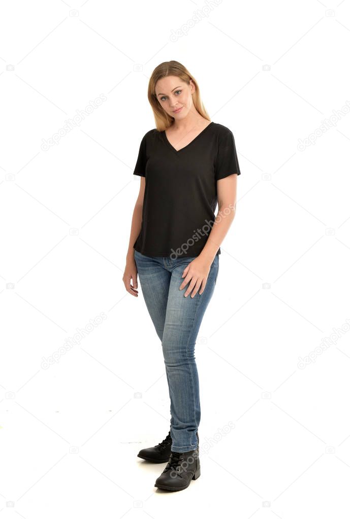 full length portrait of blonde girl wearing basic black shirt and jeans, standing pose on white background.