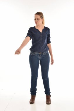 basit mavi gömlek ve pantolon giyen kız pose.isolated beyaz stüdyo arka plan üzerinde ayakta tam uzunlukta portresi.