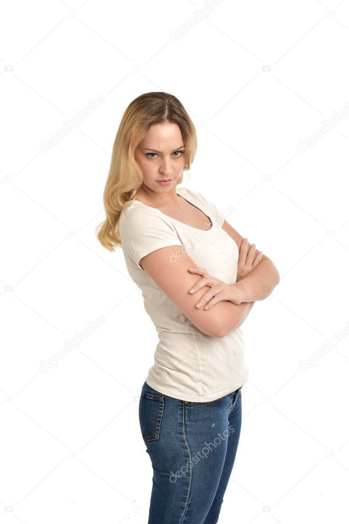 3/4 portrait of blonde girl wearing white shirt and crossing her arms. isolated on white studio background.