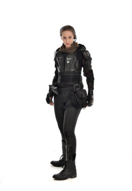 full length portrait of female  soldier wearing black  tactical armour, isolated on white studio background. clipart