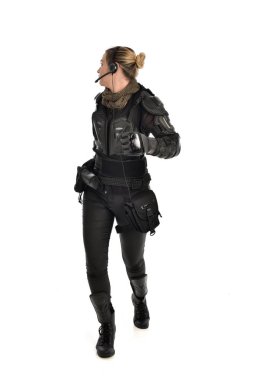 full length portrait of female  soldier wearing black  tactical armour, isolated on white studio background. clipart