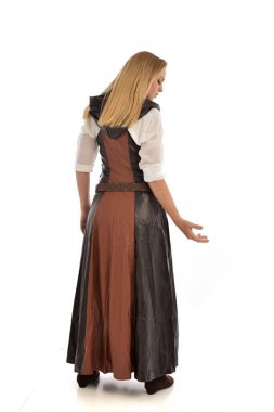 full length portrait of blonde girl wearing  brown leather fantasy outfit, standing pose with the back to the camera. isolated on white studio background. clipart