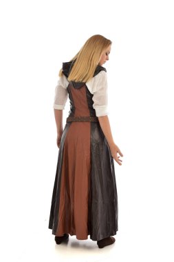 full length portrait of blonde girl wearing  brown leather fantasy outfit, standing pose with the back to the camera. isolated on white studio background. clipart
