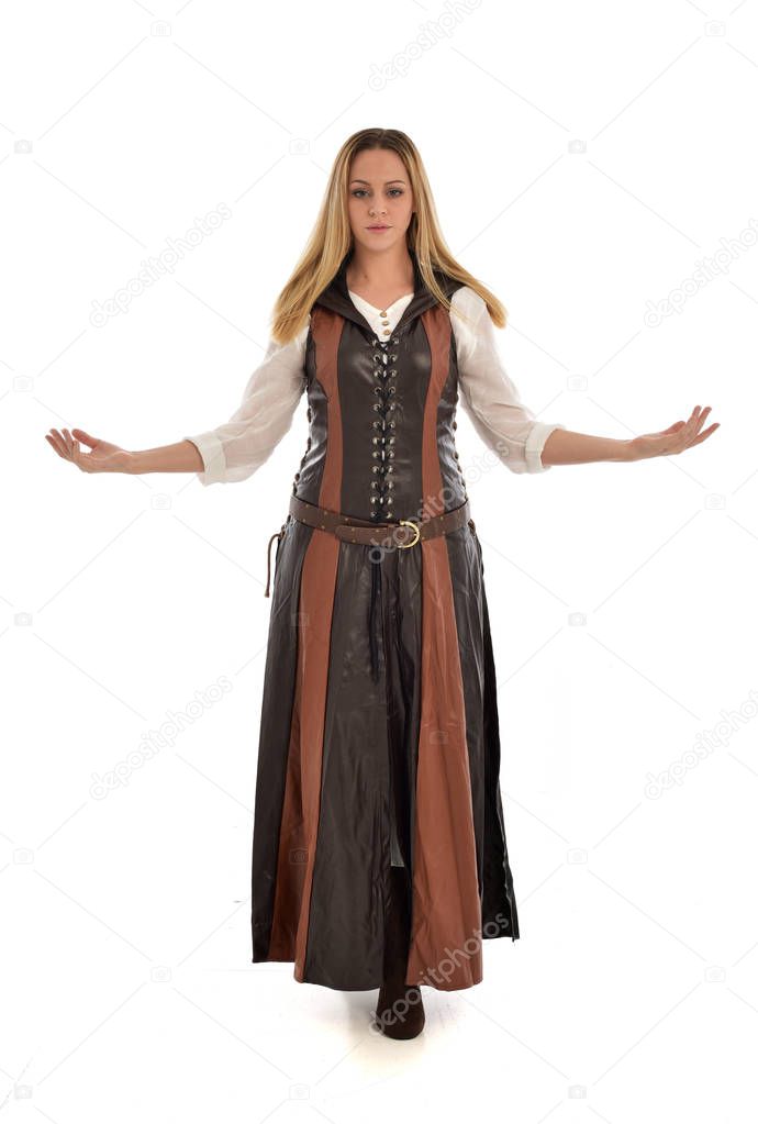 full length portrait of girl wearing brown leather medieval costume, standing pose, isolated on white studio background.