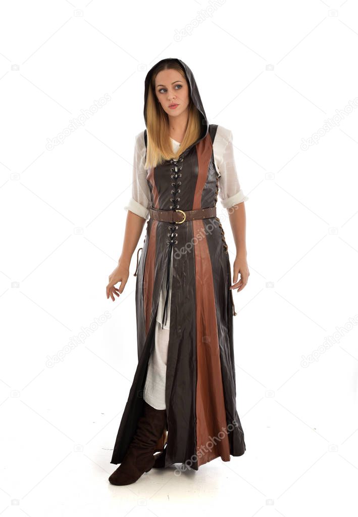 full length portrait of girl wearing brown leather medieval costume, standing pose, isolated on white studio background.