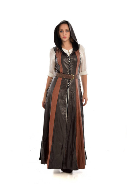 портрет девушки в коричневом кожаном средневековом костюме, стоящая поза, изолированная на белом фоне студии
.