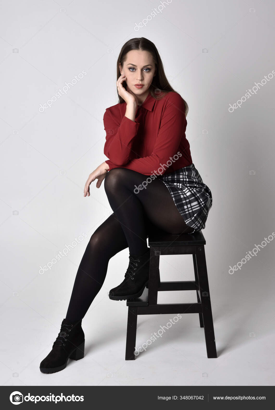 full length portrait of a pretty brunette girl wearing a red shirt