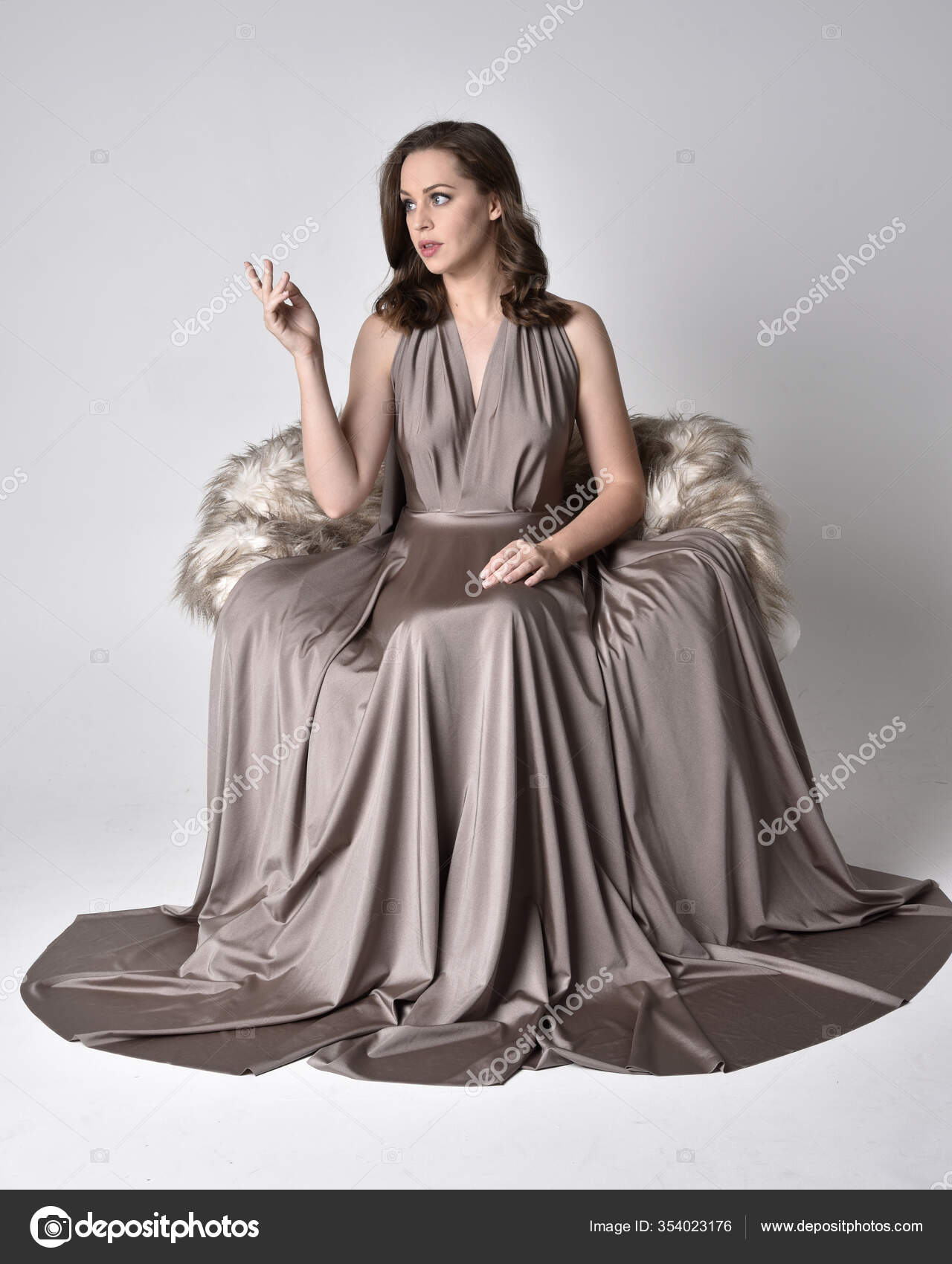 Woman in Long Dress Posing On Gray Textile · Free Stock Photo