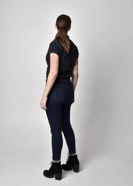 Portrait Pretty Brunette Girl Ponytail Wearing Jeans Boots Black Blouse — Stock Photo, Image