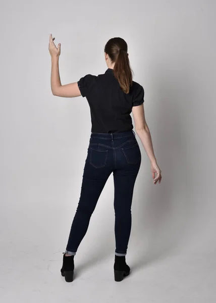 Portrait Pretty Brunette Girl Ponytail Wearing Jeans Boots Black Blouse — Stock Photo, Image