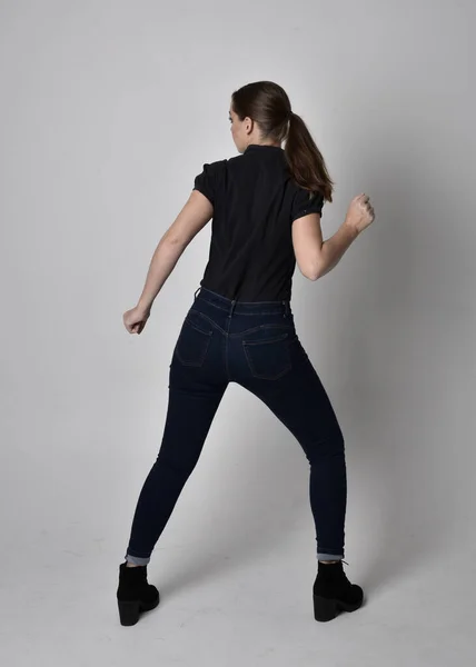 Portrait Pretty Brunette Girl Ponytail Wearing Jeans Boots Black Blouse — Stock Photo, Image