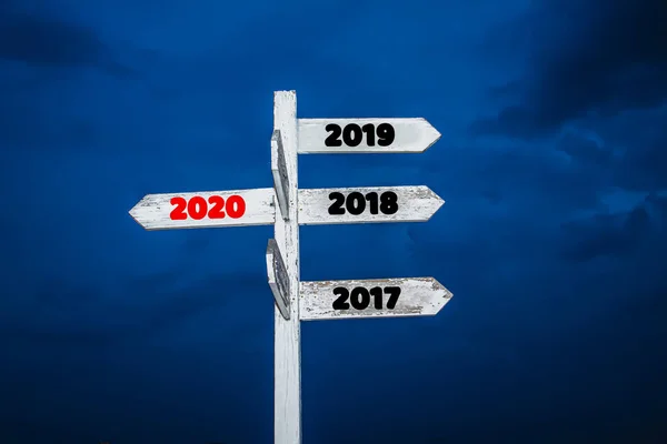 Old wooden sign are arrowheads pointing to new year 2020,with be — Stock Photo, Image