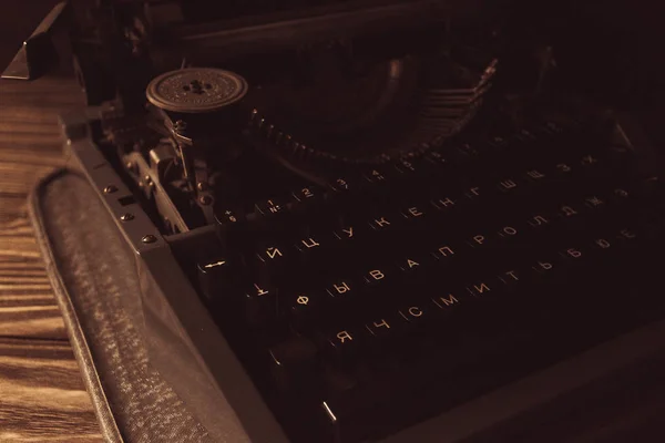 typewriter in retro style on wooden background.