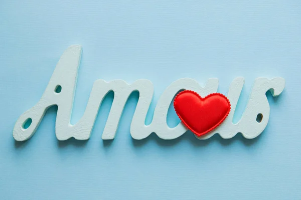 love, love. red heart and the word amour on a blue background in the centre